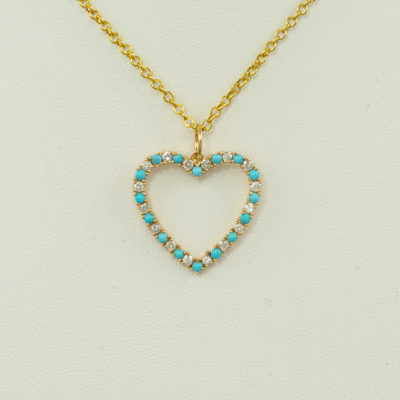This is our turquoise heart pendant. The turquoise is from the sleeping beauty mine. Accenting the turquoise are white diamonds.