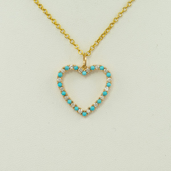 This is our turquoise heart pendant. The turquoise is from the sleeping beauty mine. Accenting the turquoise are white diamonds.