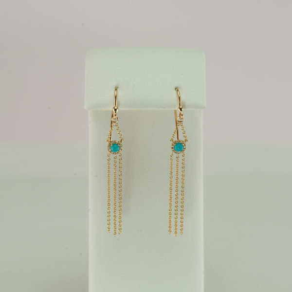 These turquoise and diamond earrings have been made with 14kt yellow gold. The turquoise is from the sleeping beauty mine.