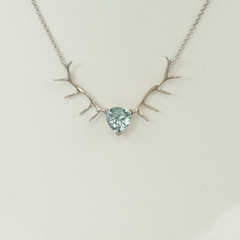This antler necklace is a one-of-a-kind. It features a trillion cut aquamarine, 14kt white gold setting and chain.