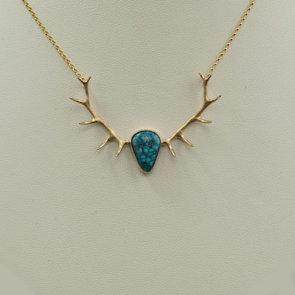 This Turquoise antler necklace was made using 14kt yellow gold. The turquoise is from the Kingman mine. The chain is 17.5" in length and has a lobster claw clasp.