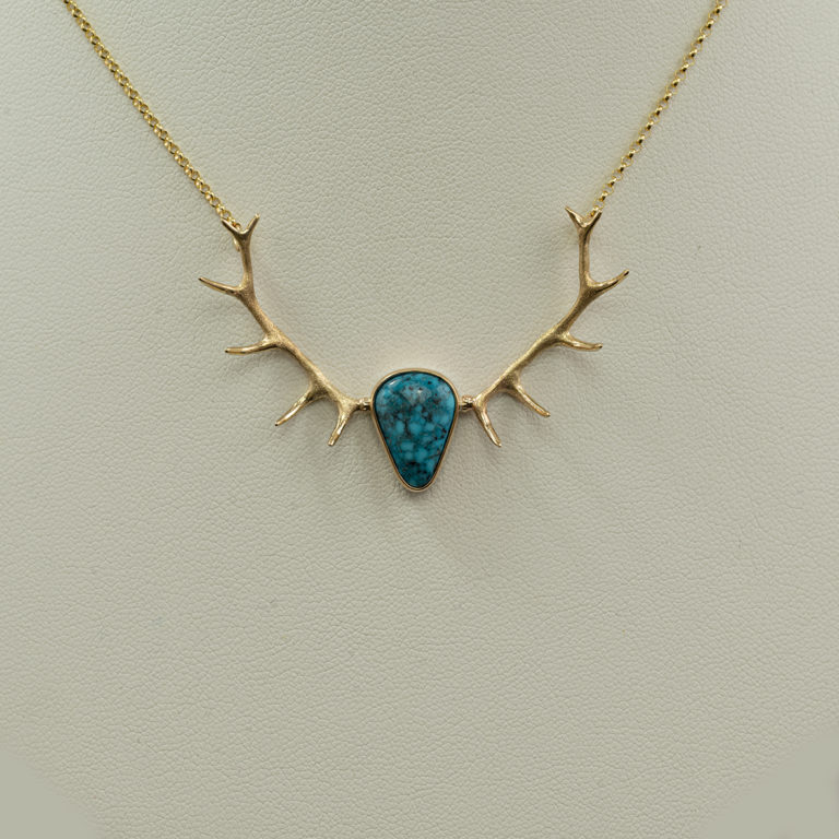 This Turquoise antler necklace was made using 14kt yellow gold. The turquoise is from the Kingman mine. The chain is 17.5" in length and has a lobster claw clasp.
