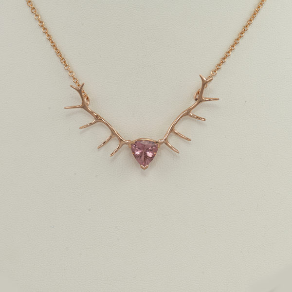 This is our rose gold antler with pink tourmaline. The tourmaline is a trillion cut and the gold is 14kt. The chain has a lobster claw closure.