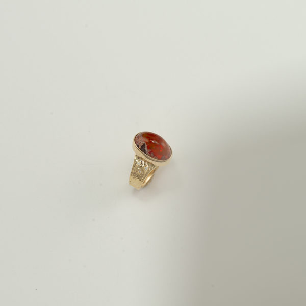 This is our only fire opal ring in the whole gallery. It has been set in 14kt yellow gold and has diamond accents. The white diamonds have a total carat weight of .06 and are (SI1-GH). Shown in a size 7, but can be re-sized.