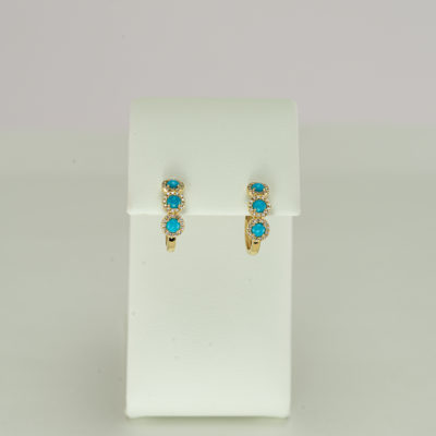 This pair of turquoise hoops has diamond accents. Both the diamonds and the turquoise have been set in 14kt yellow gold. We offer several styles of necklaces to match. The turquoise is from the sleeping beauty mine.