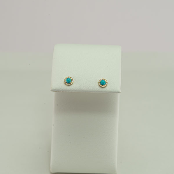 This is our smallest pair of tiny turquoise studs. These earrings were made with 14kt yellow gold and have diamond accents. We have several necklaces to match.