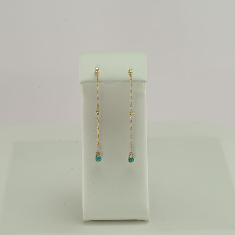 This pair of turquoise earrings was made with 14kt gold and diamond accents. We have a variety of necklaces to match.