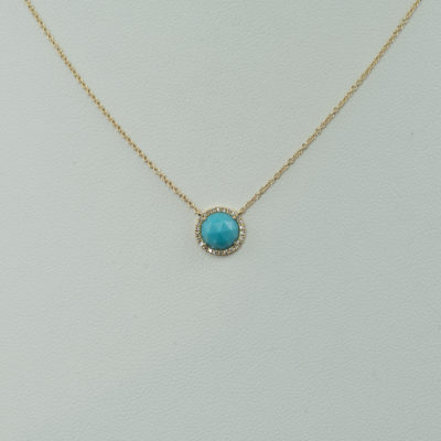 This turquoise necklace has diamond accents. The turquoise is from the sleeping beauty mine and the diamonds are white. Both the diamonds and the turquoise have been set in 14kt yellow gold. We have earrings to match and offer the pendant and earrings in a larger size as well.