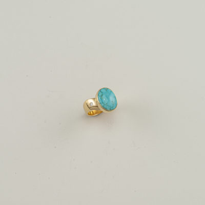This turquoise ring has diamond accents. Both the turquoise and the diamonds have been set in 14kt yellow gold. Shown in a size 6, but can be re-sized.