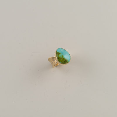 This ring is made with Sonoran gold turquoise. Our designer has added some diamond accents to the turquoise.