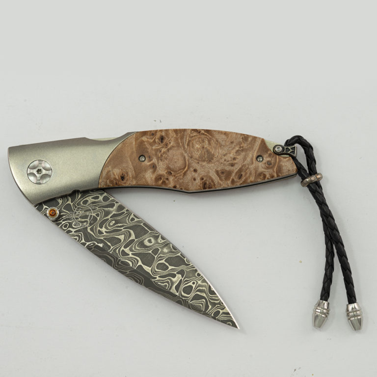 This is the maple by William Henry. It is 44 of 250 produced. Featuring intrepid damascus, titanium, citrine and maple.
