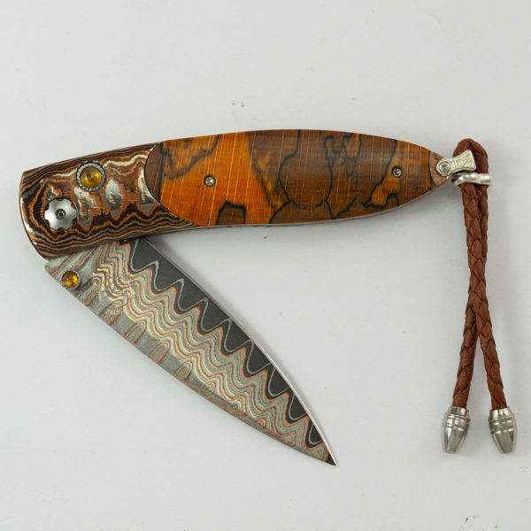 This knife is the copper ridge by William Henry. It is 7 of 250 produced and features spalted beech wood, mokume gane.