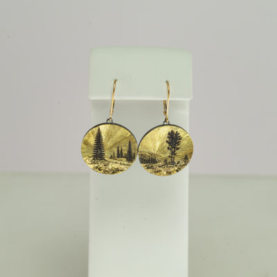 This pair of gold mountain earrings were hand made. The artist is Wolfgang Vaatz. He used a combination of silver and gold.