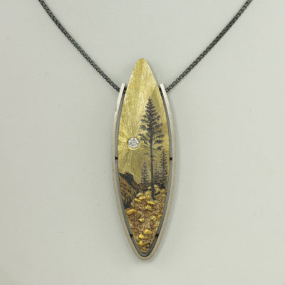 This is a mountain pendant by Wolfgang Vaatz. It was made with Silver, 18kt gold, 24kt gold and a diamond for the "sun".