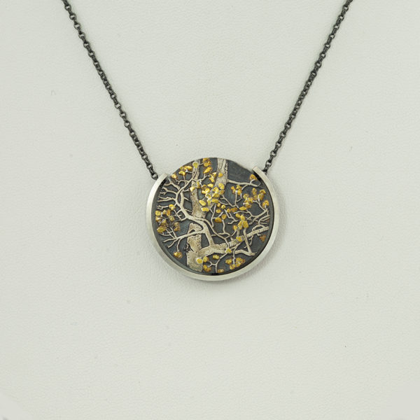 This is the aspen branches pendant. It incorporates sterling silver, argentium silver and 24kt gold. The chain is adjustable.