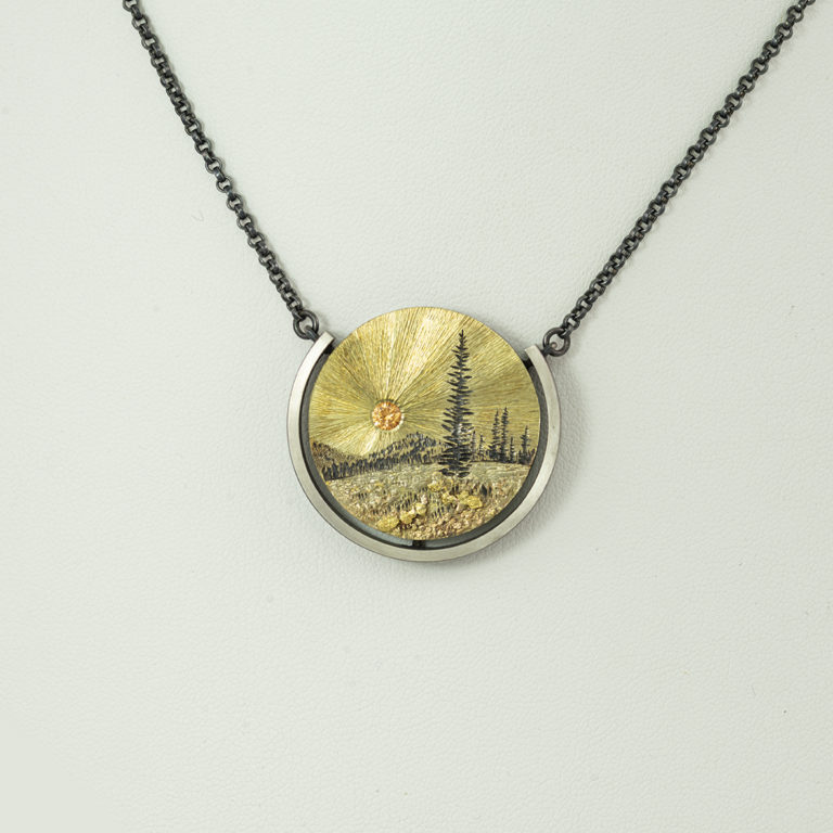 Gold mountain pendant with garnet