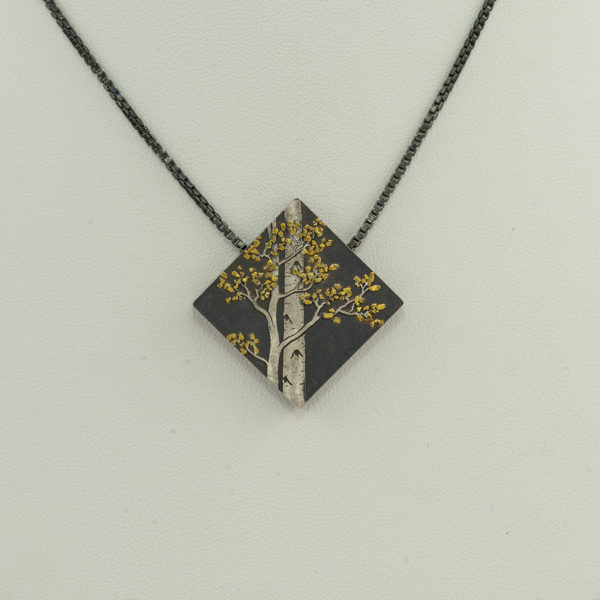 This two tone aspen pendant has an adjustable chain. The piece was created by Wolfgang Vaatz with two types of silver and 24kt gold. 