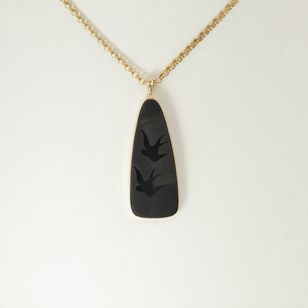 This bird pendant is one-of-a-kind. The birds have been carved in black onyx. The black onyx has been set in 14kt yellow gold.