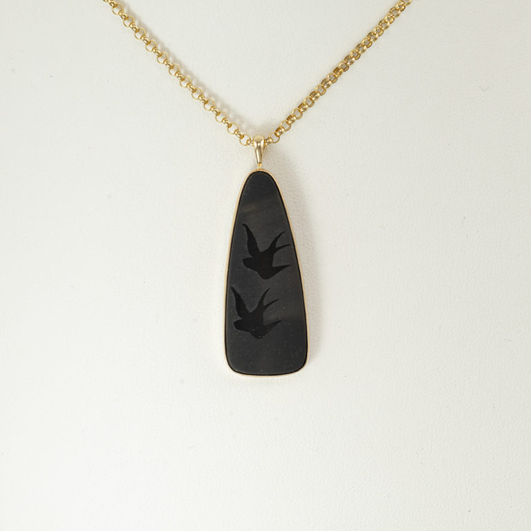 This bird pendant is one-of-a-kind. The birds have been carved in black onyx. The black onyx has been set in 14kt yellow gold.