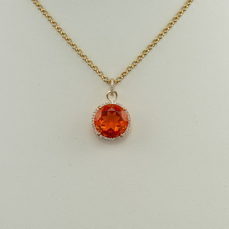 Fire opal pendant with diamond accents set in 14kt yellow gold.