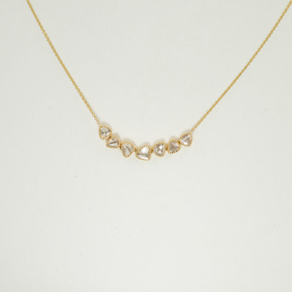 This is an 18kt gold and diamond necklace. The gold was given a mill grain edge and the chain is adjustable. 