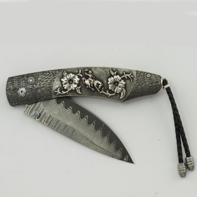 This is the Ride by William Henry. This is 33 of 50 produced. It features two types of damascus, blue topaz.