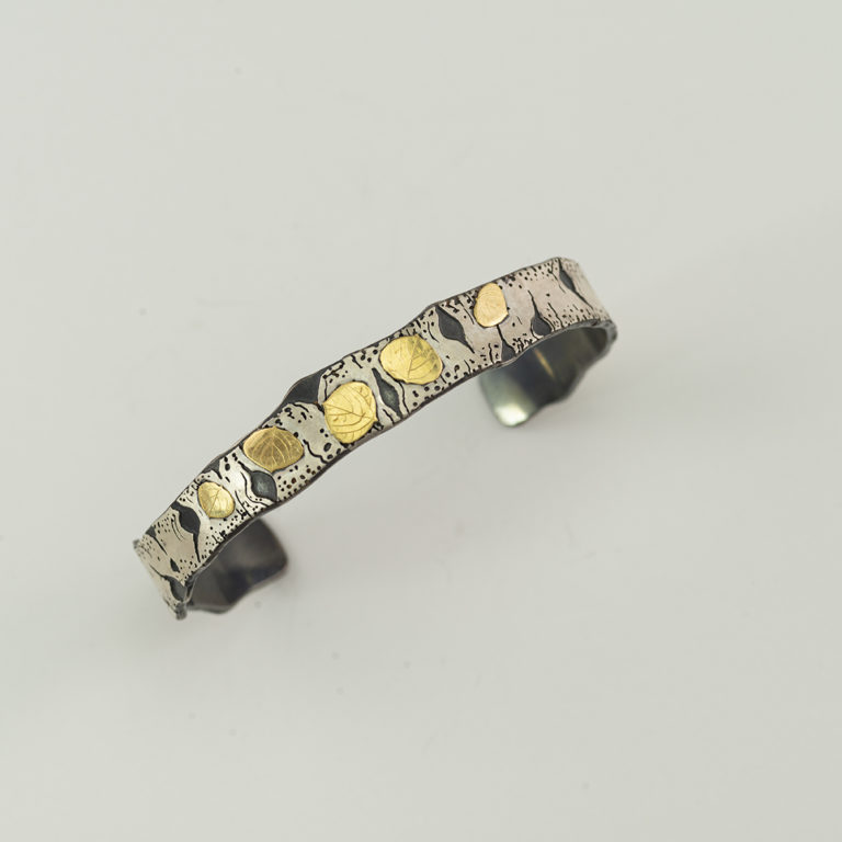 Here is the silver and gold aspen cuff by Wolfgang. The silver is Argentium and the gold is 18kt gold. Shown in a size XL.