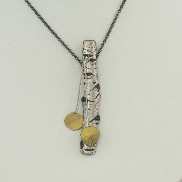 This is the aspen pendant in two tone. This has been hand made by Wolfgang Vaatz. This pendant incorporates sterling silver, argentium silver and 18kt yellow gold.