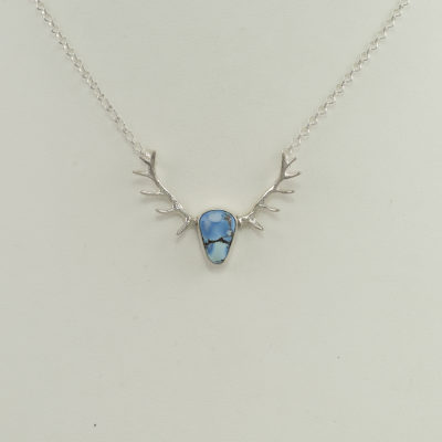 Here is a small antler pendant. It has been cast in sterling silver and has turquoise center stone. It measures 18" in length and has a lobster claw clasp.
