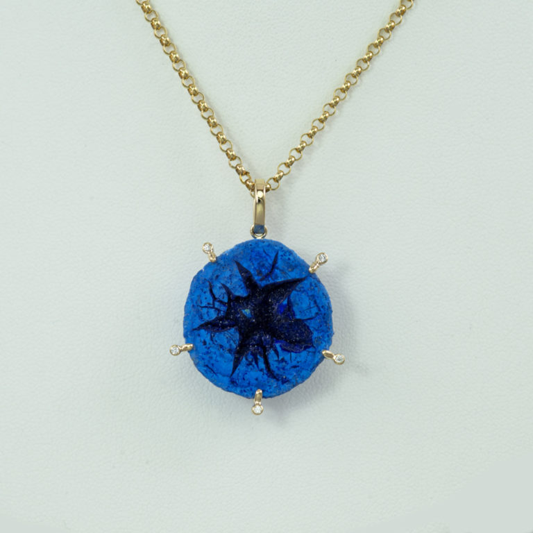 This azurite pendant is one of a kind. The azurite is a geode with a crystalline formation in the center. The geode has been set in 14kt.
