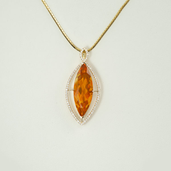 This incredible one-of-a-kind Fire Opal Marquise Pendant is set in 14KT yellow gold and adorned with .38cts of white diamonds.