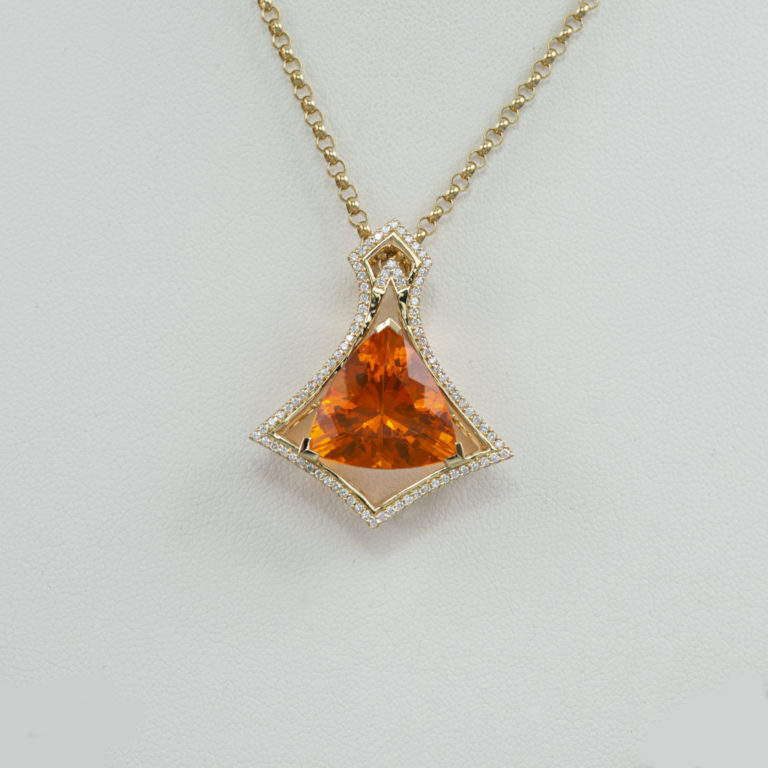 This is our one of a kind Fire Opal Trillion Pendant, accented with white diamonds. This pendant is set in 18KT yellow gold