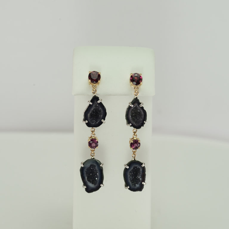 Here are a pair of garnet and geode earrings.  The have been set in sterling silver and 14kt yellow gold. This pair is one of a kind.
