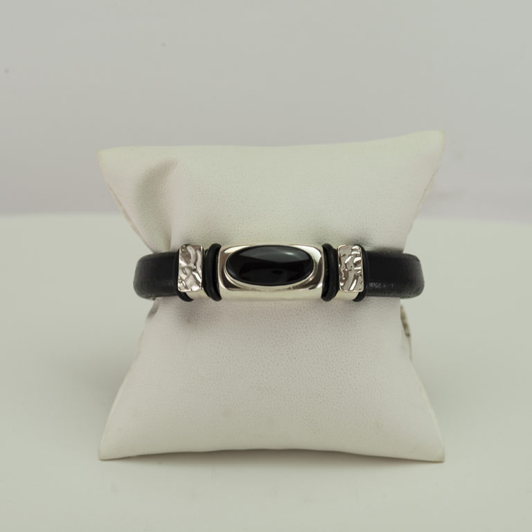 Here is a Wyoming black jade bracelet. The jade has been set in a sterling silver bead. The bracelet itself is made with leather. The clasp is a stainless steel and the length is 7".