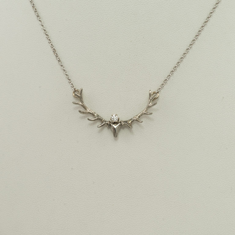 This white gold antler pendant has a white diamond. The chain is included in the price. This is the smaller of the two antler styles we offer.