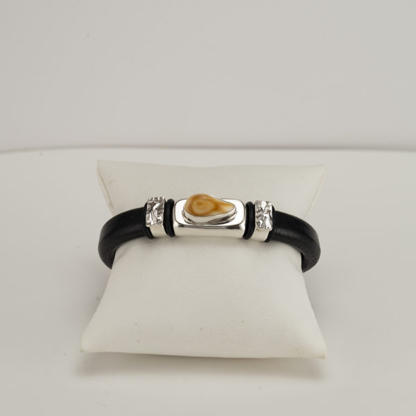 This elk ivory cuff has silver accents. The leather is cowhide with a magnetic, stainless steel clasp. This is a size 7.5, but can be re-sized.