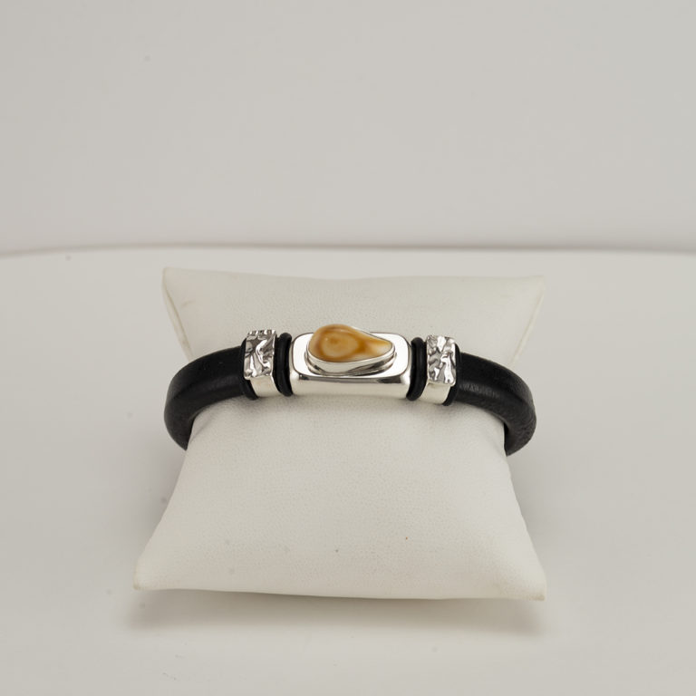 This elk ivory cuff has silver accents. The leather is cowhide with a magnetic, stainless steel clasp. This is a size 7.5, but can be re-sized.
