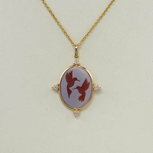 Here is a hummingbird pendant with diamond accents. The hummingbirds are a hand carved agate cameo. The diamonds are brilliant cut.