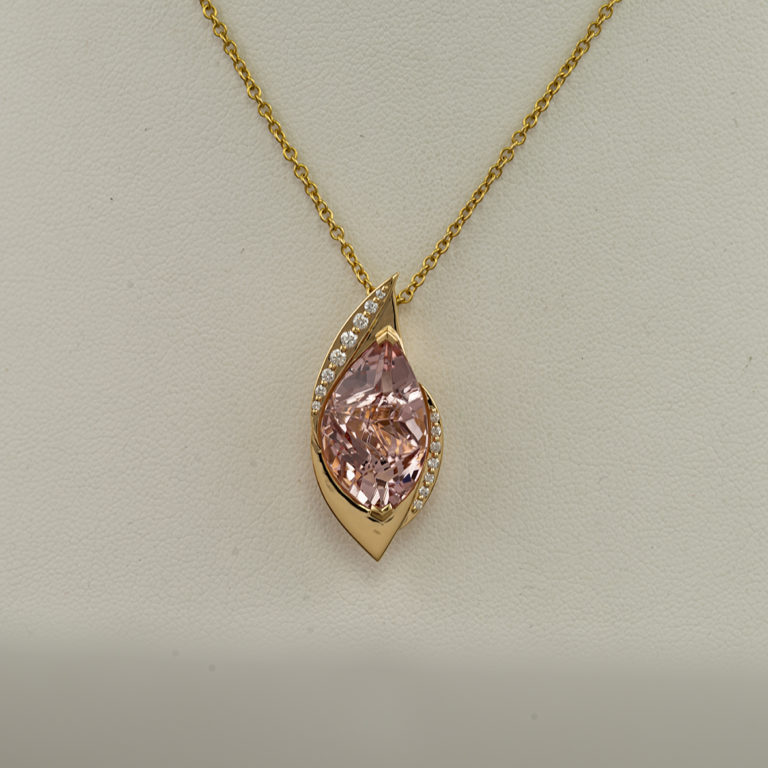 This morganite pendant has been set in 18kt yellow gold. The morganite has been accented with white diamonds. We have earrings to match.