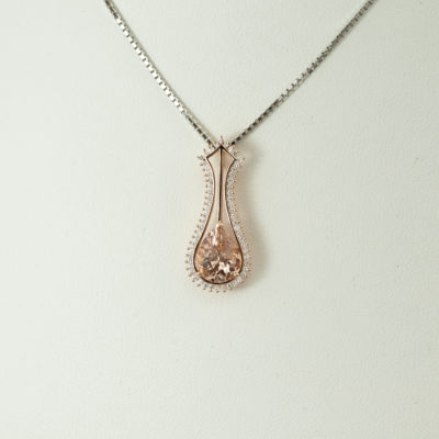 This morganite pendant has been made with 14kt rose gold and white diamond accents. The morganite is a pear cut and the diamonds are round cut.