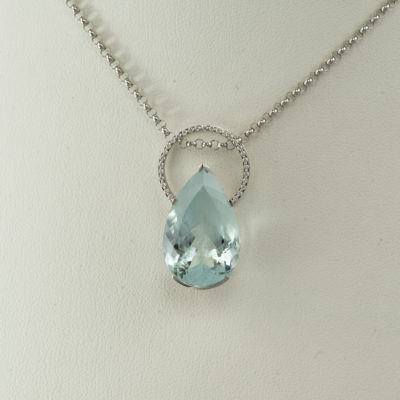 This pear cut aquamarine has diamond accents. Both the diamonds and the aquamarine have been set in 14kt white gold. This is a one of a kind and the chain is not included in the price.