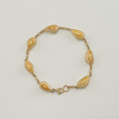 Gold elk ivory bracelet with diamonds and lobster claw clasp.