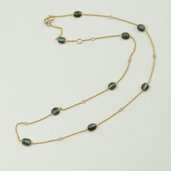 This cat's eye tourmaline necklace is one-of-a-kind. Accenting the tourmaline are little white diamonds. The length is adjustable.