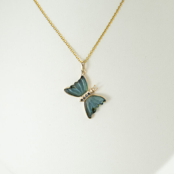 Here is a blue butterfly pendant. It has blue diamond accents. The piece was cast in 14kt yellow gold and the chain is sold separately.