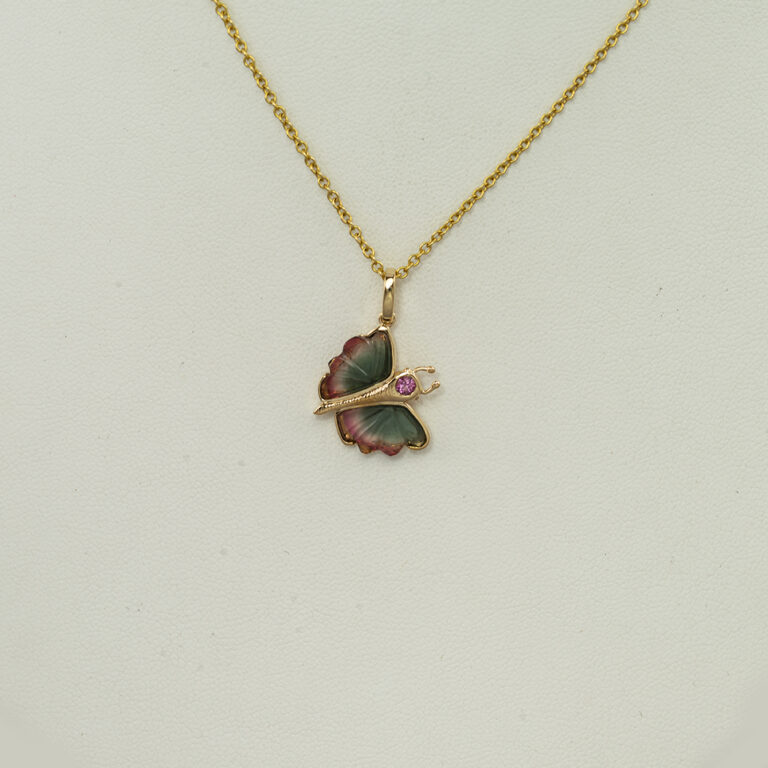 This small butterfly pendant has carved tourmaline wings, a faceted pink tourmaline and 14kt yellow gold. The chain is sold separately. 