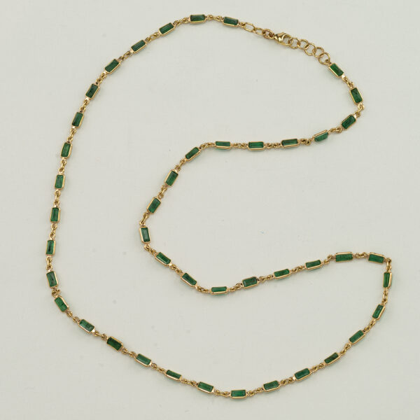 This emerald necklace was set in 14kt yellow gold. There is 7.74cts total weight of emeralds. The length is 18".