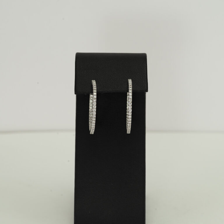 Here is a pair of in n' out diamond hoops. The diamonds have been set in 14kt white gold. The total carat weight of the diamonds is 1.11.