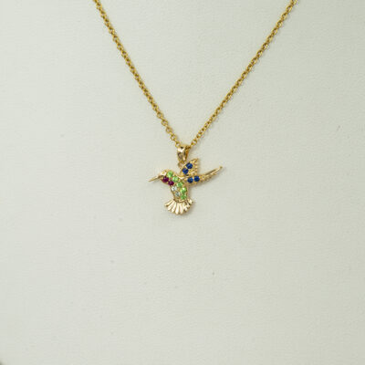 Small hummingbird pendant in yellow gold with gemstones.