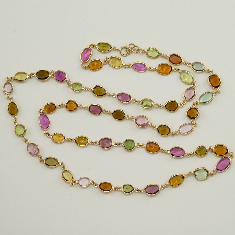 This tourmaline necklace has been made with 14kt yellow gold. All of the tourmaline cabachons are multi colored. The total length is 24".