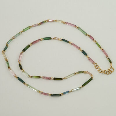 Here is a tourmaline crystal necklace. The tourmalines are multi-colored and set in 14kt yellow gold. The total length is 18".